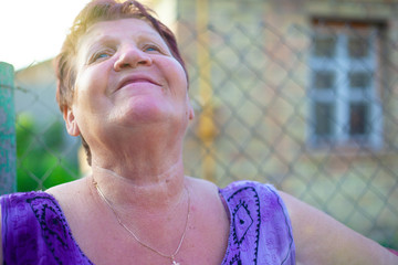 happy 60 year old age concept,village grandmother rejoices and looks to the sky,grandma without...