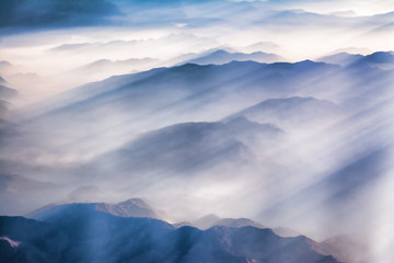 Obraz na płótnie Canvas clouds over the Himalayan mountain range with streaks of sun rays