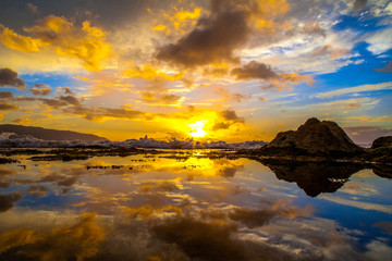 Fototapeta na wymiar Amazing North Shore Oahu sunset reflected in a tide pool