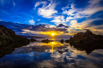 Amazing North Shore Oahu sunset reflected in a tide pool