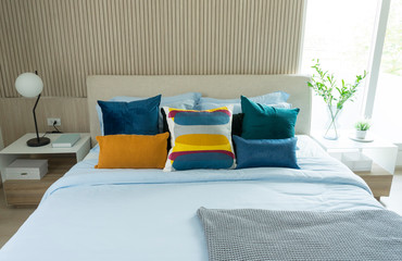 Modern and stylish of cozy bedroom with colorful bedding on bed