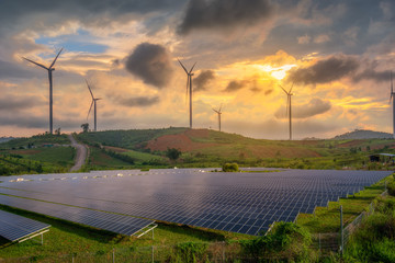 solar panels and wind turbines generating electricity in power station green energy renewable with sunset  background - obrazy, fototapety, plakaty