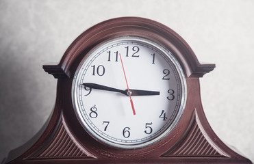 Clock on white wall background.