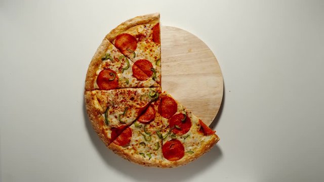 CLOCKWISE: Whole Circle Of Big Pizza Is Eaten Up On The Wooden Board, White Background