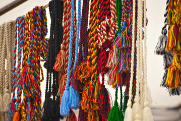 Rope and colored thread ornaments are sold at the fair