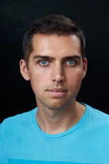 portrait of young man on black background