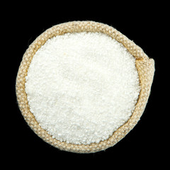 Citric acid in a bag isolated on a black background. View from above.