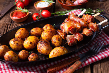 Rustic dates wrapped in bacon and young roasted potato.