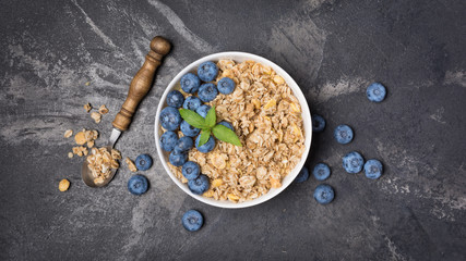 Obraz na płótnie Canvas Oat flakes or granola with fresh blueberry for healthy breakfast