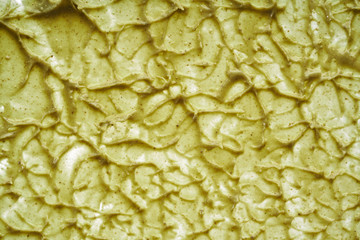 Texture and strokes of a light green organic mask for face or body cream isolated on white background