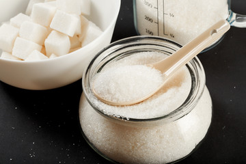 bowl of sugar  on black background