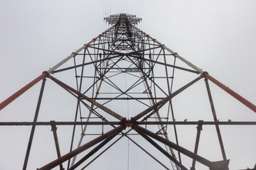 High voltage pole against gray sky