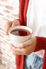 Woman holding cup of hot tea, closeup