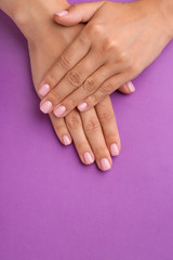 Female hands with beautiful manicure on color background