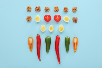 Quail eggs with nuts and vegetables on color background