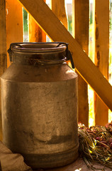 milk can is in a wooden shed