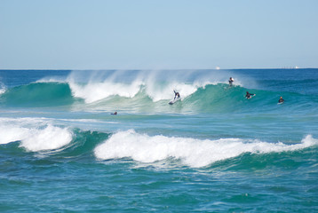 Surfers on clear cold winter morning at Trigg Beach Western Australia
