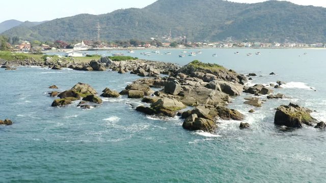 Rocky coastline with turquoise colored water, Praia Armacao, Florianopolis, Santa Catarina, Brazil