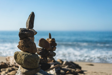 balanced stacks of stones at the beach