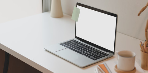 Minimal comfortable room with open blank screen laptop