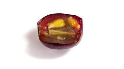 Half of grape berry isolated on white background.