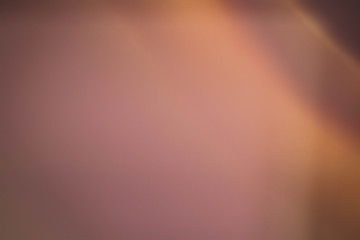 Smeared light glow. Copper colored abstract art background. Blur lens flare design.