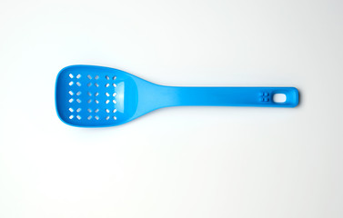 blue plastic spoon with holes for mixing salad