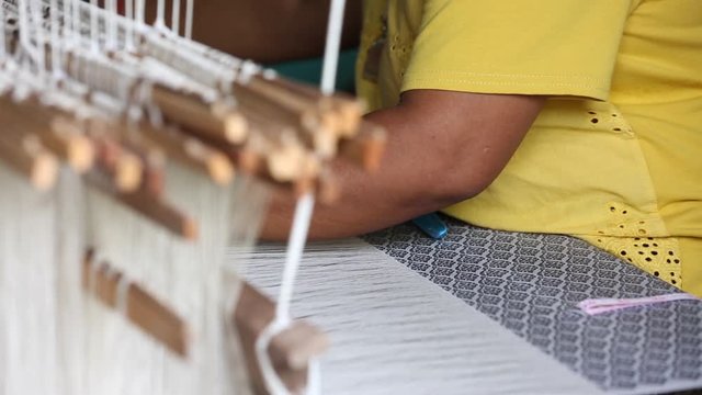 weave silk cotton on the manual wood loom ,Thailand,selective focus,vintage color