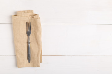 Fototapeta premium top view of fork and knife on checkered napkin