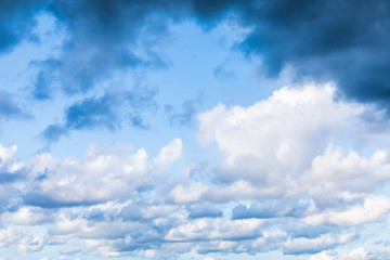 The vivid sky or heaven background with white and blue clouds under the sun rays