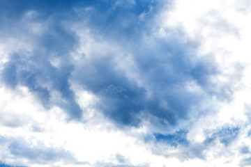 The vivid sky or heaven background with white and blue clouds under the sun rays