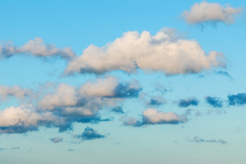 The vivid sky or heaven background with white and blue clouds under the sun rays