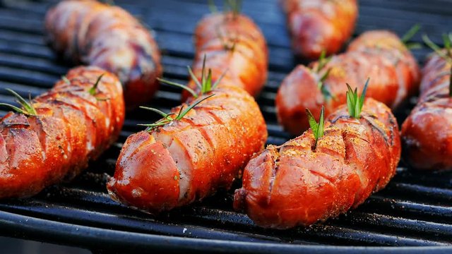 Closeup of spicy sausage on hot grill