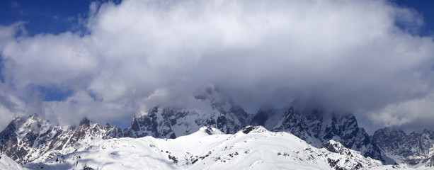 Fototapeta na wymiar Mount Ushba in clouds at winter