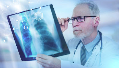 Senior doctor looking at x-ray; multiple exposure