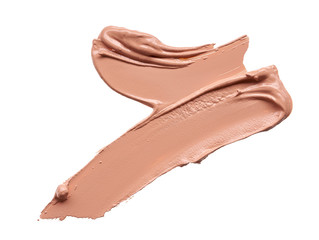 Gently beige strokes and texture of makeup foundation or acrylic paint isolated on white background