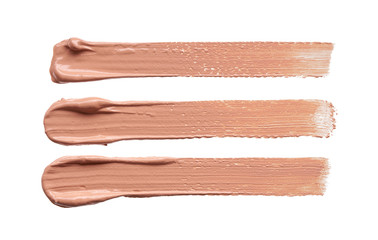 Gently beige strokes and texture of makeup foundation or acrylic paint isolated on white background