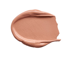 Gently beige strokes and texture of makeup foundation or acrylic paint isolated on white background