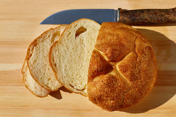sliced bread lying on the table and knife top view