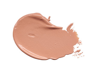 Gently beige strokes and texture of makeup foundation or acrylic paint isolated on white background