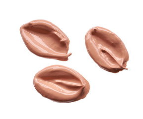 Gently beige strokes and texture of makeup foundation or acrylic paint isolated on white background
