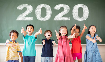 Multi-ethnic group of school children standing in classroom