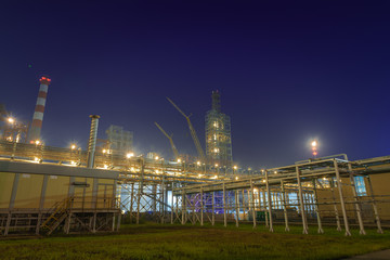 Fototapeta na wymiar view of metal pipes of industrial plant outdoor at night 