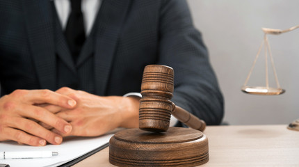 Law and Legal services concept. Male lawyer or judge working with contract papers, Law books and...