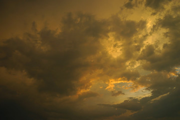   Summer evening sky, golden color on the clouds, a beautiful combination of warm and cold colors. 