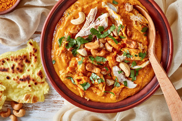 hearty spicy Mulligatawny soup in a  clay bowl