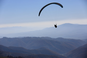 paraglider fly over mountains
