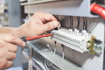 The electrician performs the installation and configuration of high-voltage equipment.
