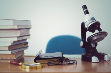 Fototapeta premium books and microscope on the table