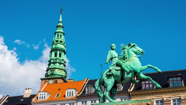 Copenhagen, Denmark. Vie wof Bishop Absalon statue and Nikolaj Copenhagen Contemporary Art Center in Copenhagen, Denmark. Time-lapse during a sunny summer day with clouds in the blue sky